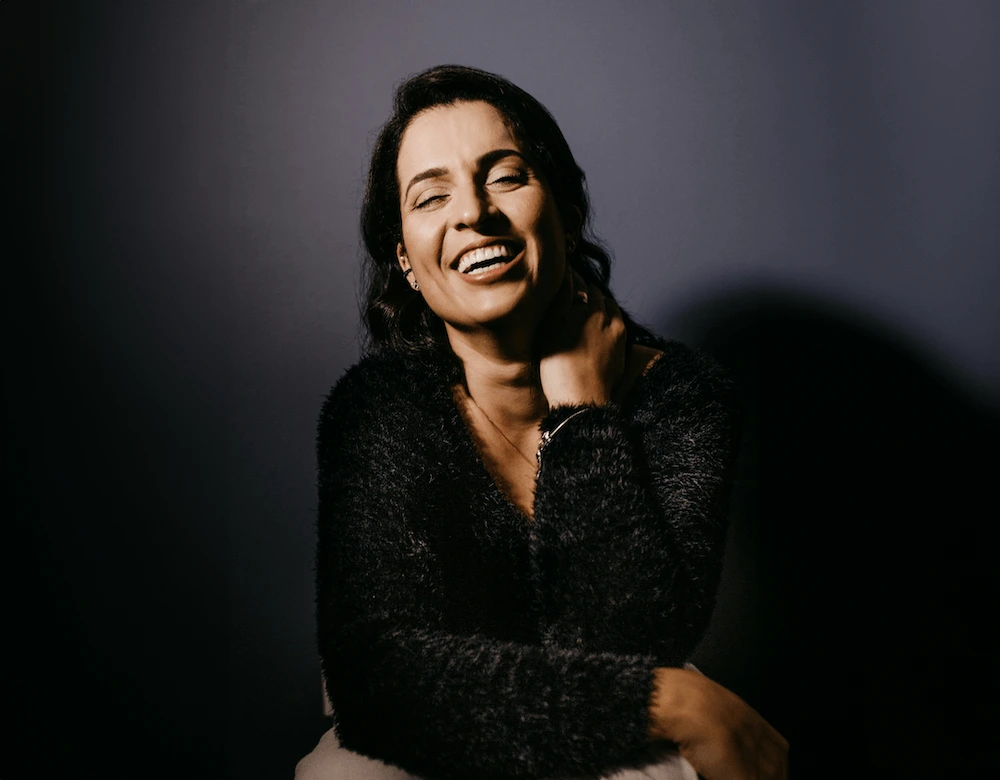 joyful woman on dark background