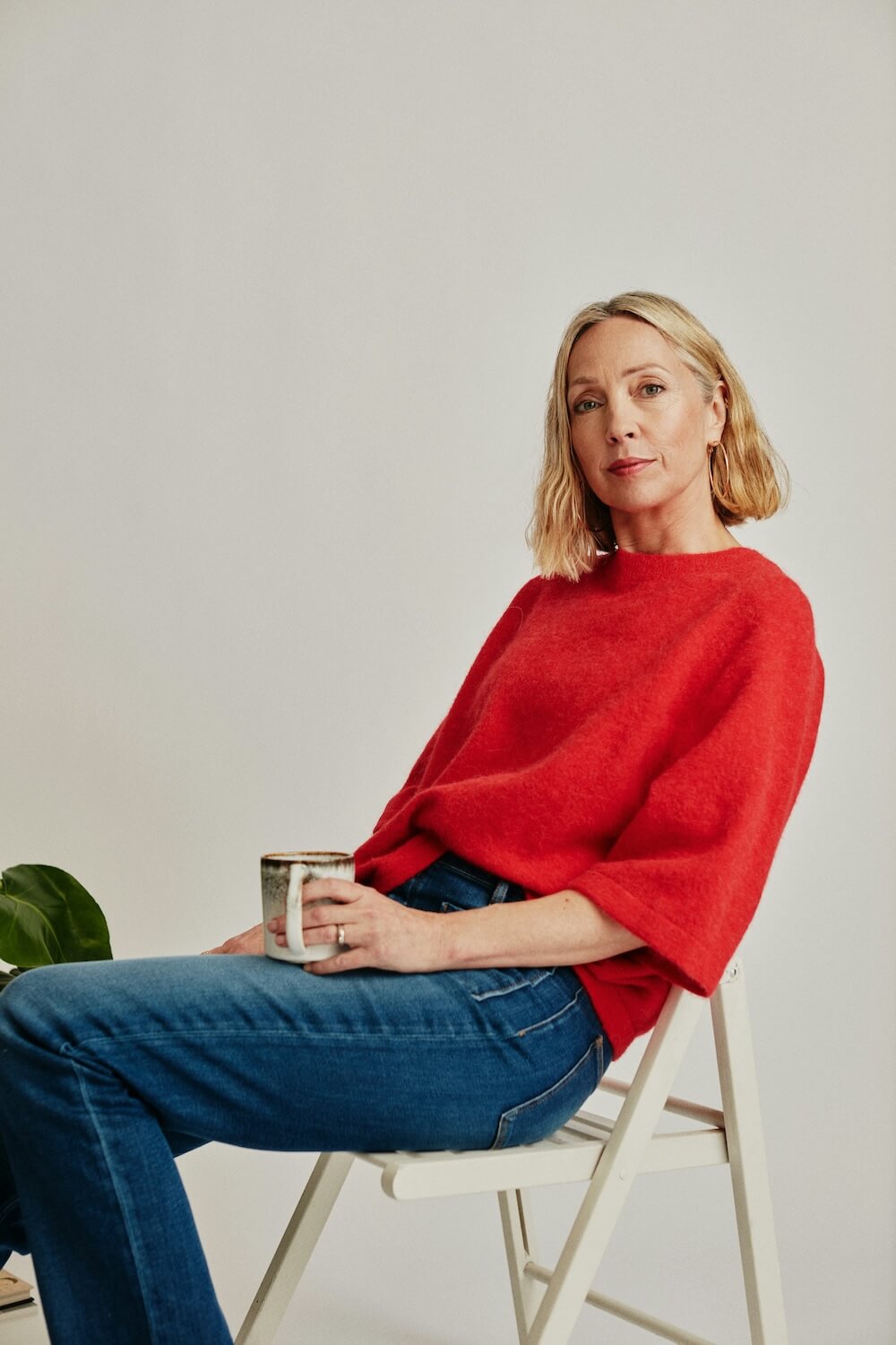 A woman in mid-life relaxes with a coffee